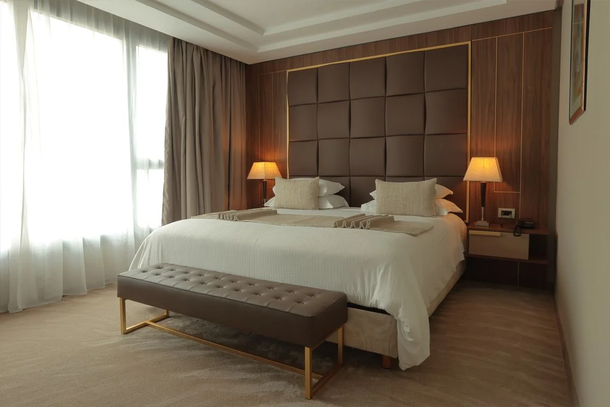 Signature suite with leather headboard and gold trim
